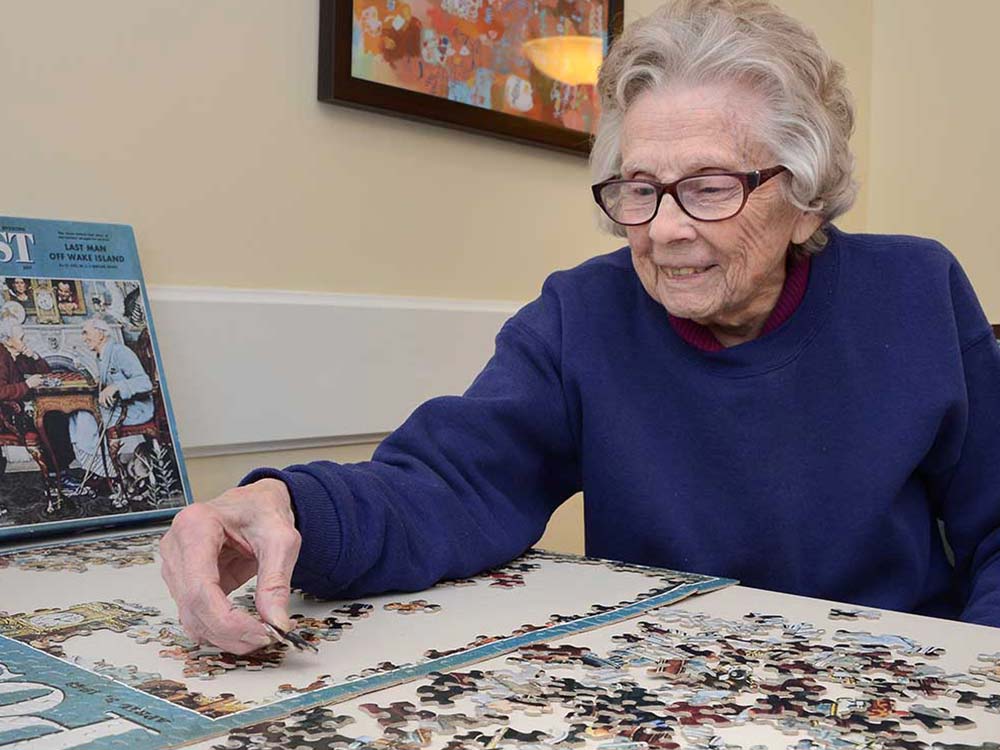 woman puts puzzle together