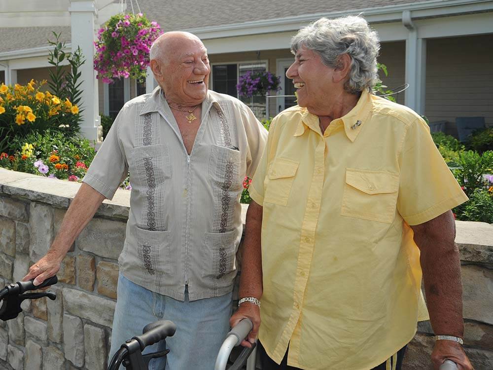 2 resident share a joke while standing outside