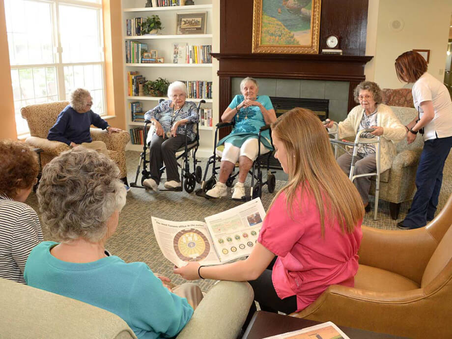 residents sit in the living talking and reading